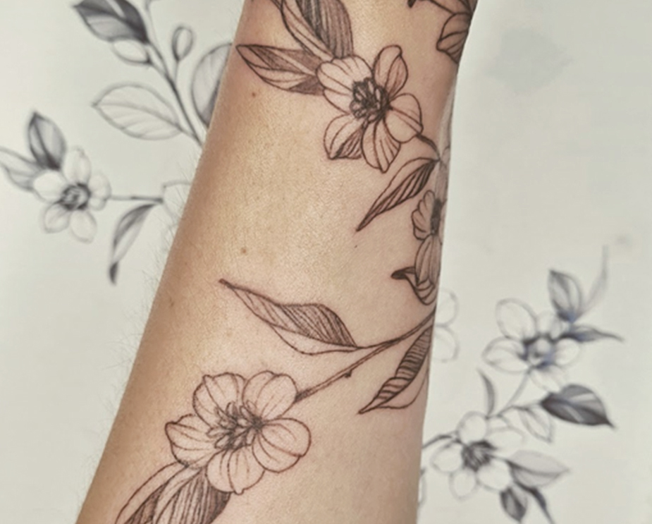 Small and delicate modern Tattoo with flowers for women in Lucerna.